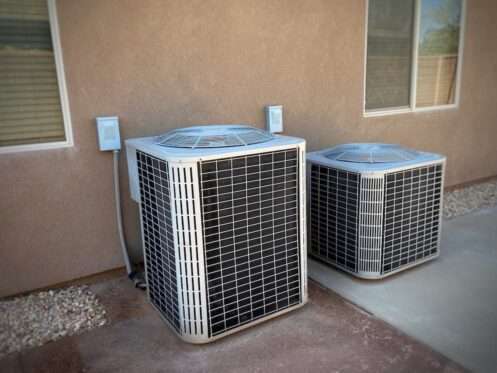 Residential HVAC units that require professional repair or AC service, suggesting a cooling or mechanical failure.